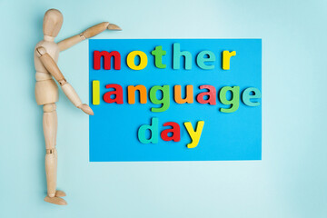 Word international mother language day text on a blue background. Top view. Copy Space