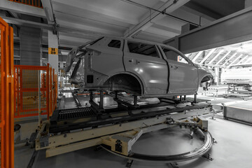 Car body is on assembly line. Factory for production of cars. Modern automotive industry. Auto plant concept