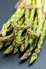 Fresh of green Asparagus. Cooking healthy meal. Bunches of green asparagus. Vertical photo