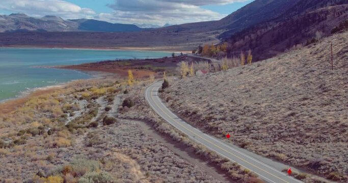 Aerial view of car on country road & mono lake, California