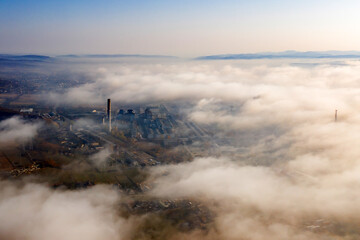 Aerial view of industrial zone covered with autumn fog in Dej, Romania.