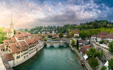 Fototapeta na wymiar Travel to Bern. Sunrise photographed in this beautiful city from Switzerland. Photo taken next to Aare river with view to the entire old part of the town.