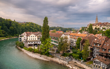 Fototapeta na wymiar Travel to Bern. Sunrise photographed in this beautiful city from Switzerland. Photo taken next to Aare river with view to the entire old part of the town.