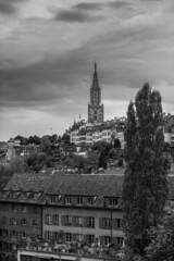 Bern in black and white. A cloudy morning with dramatic sky in the capital city of Switzerland. View to Berner Münster cathedral.
