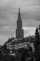 Bern in black and white. A cloudy morning with dramatic sky in the capital city of Switzerland. View to Berner Münster cathedral.