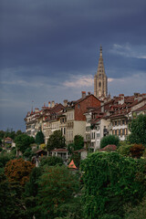 Fototapeta premium Travel to Switzerland. Berner Münster cathedral with amazing architecture tower photographed during a cloudy morning. Landmark of this city from Bern.