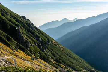 Fototapeta premium Morning in the mountains, i.e. a classic view of the autumn fog between the ridges.