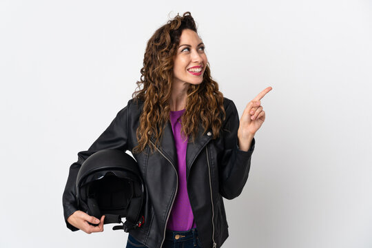 Young caucasian woman holding a motorcycle helmet intending to realizes the solution while lifting a finger up
