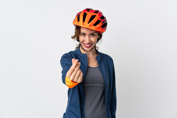 Young cyclist woman isolated on white background making money gesture