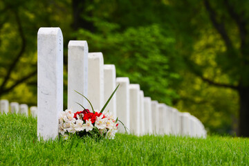 Headstones and National flags in Arlington National Cemetery - Circa Washington D.C. United States of America	