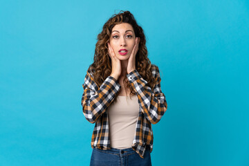 Young caucasian woman isolated on blue background frustrated and covering ears