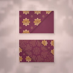 Presentable burgundy business card with antique gold ornaments for your brand.