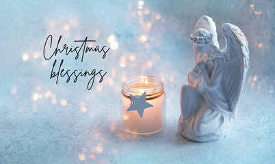 Christmas blessings greeting card. Praying angel and candle on abstract background with garland...