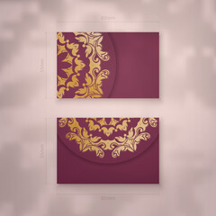 Presentable burgundy business card with antique gold ornaments for your business.