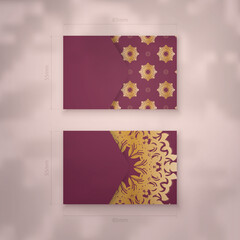 Presentable burgundy business card with antique gold pattern for your personality.