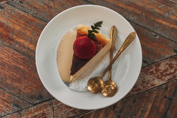 Burnt Cheese Cake with strawberry on top served on wooden table.