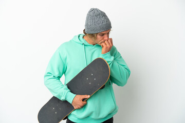 Young skater blonde man isolated on white background having doubts