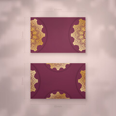 Presentable burgundy business card with Greek gold pattern for your personality.