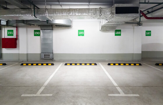 Underground car parking, empty light parking lot indoor