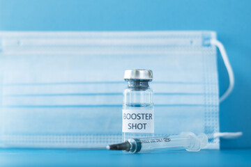 booster shot of coronavirus vaccine on a blue background,revaccination, protection against infection with covid-19