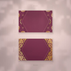 Presentable burgundy business card with Indian gold pattern for your personality.