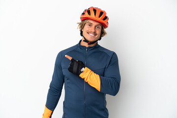 Young blonde cyclist man isolated on white background pointing to the side to present a product