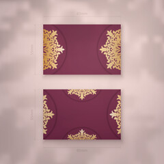 Presentable burgundy business card with luxurious gold ornaments for your personality.