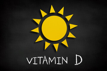 Vitamin D concept, sun icon on blackboard