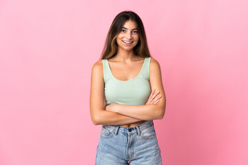 Young caucasian woman isolated on pink background keeping the arms crossed in frontal position