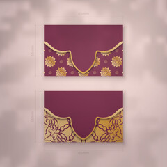 Presentable burgundy business card with mandala gold pattern for your business.