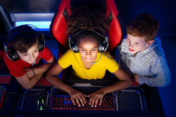 Top view of children playing video games together on the computer.