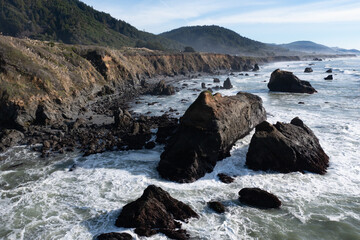 Fototapeta na wymiar The cold Pacific Ocean washes onto the rugged coastline of Northern California north of Fort Bragg. The Pacific Coast Highway runs right along this scenic region in Mendocino County.