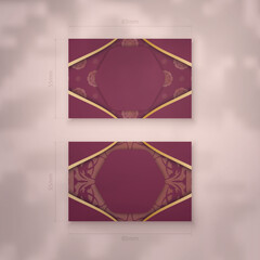Presentable business card in burgundy color with abstract gold pattern for your contacts.