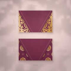 Presentable business card in burgundy color with Greek gold pattern for your contacts.