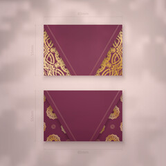 Presentable business card in burgundy color with luxurious gold ornaments for your contacts.