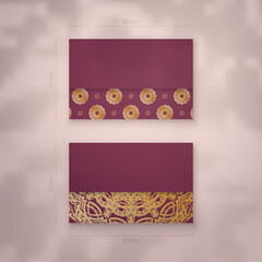 Presentable business card in burgundy color with luxurious gold ornaments for your personality.