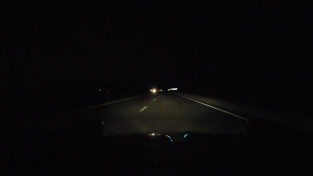 Late Night Highway Driving With Oncoming Truck Lights In Opposite Lane