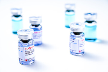 Coronavirus vaccine, COVID-19 vaccine, corona vaccination. Different vials of mRNA vaccine for injection on white background.