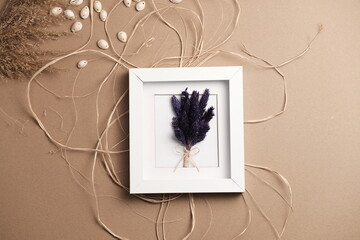 dried colorful flower in frame and seashells