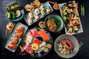 Assorted Chinese food set. Chinese noodles, dim sum, Famous Chinese cuisine dishes on black table. Top view. Chinese restaurant concept. Asian style