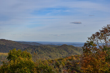 Obraz na płótnie Canvas Shenandoah National Park, Virginia, USA - November 3, 2021: Mountain Scenery With Beautiful Fall Trees in the Foreground and a Bright Blue Sky in the Background