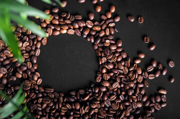 Texture of coffee beans close-up on black background and copy space.