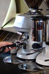 Espresso coffee beans and coffee grinder in a small coffee shop