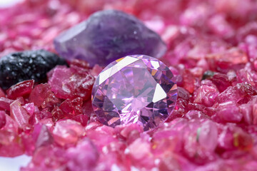 amethyst diamonds on placed on a pile of raw ruby rough gemstone..colorful raw stone...