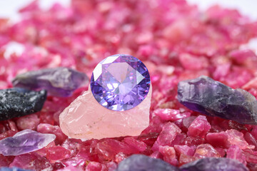 amethyst diamonds on placed on a pile of raw ruby rough gemstone..colorful raw stone...