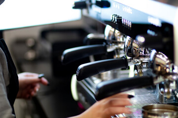 Fototapeta na wymiar Close up pic of a proffesionnal coffee machine in a coffee shop preparing hot coffee