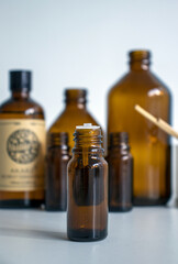 various amber glass bottles for cosmetics, natural medicine , essential oils or other liquids isolated on a white background, top view

