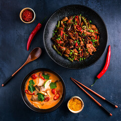 Traditional Chinese or Thai food set. Chinese noodles, fried rice with chicken, tom yum soup,deep fried fish and udon with shrimps. Asian style food concept.