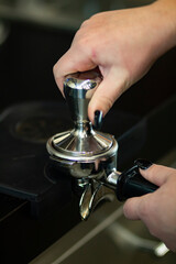 Espresso coffee beans and coffee grinder in a small coffee shop