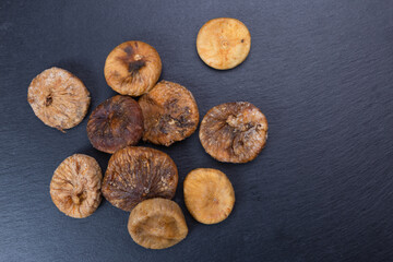 sweet dried figs in a wooden plate. organic fruits for a healthy lifestyle. vegetarian food